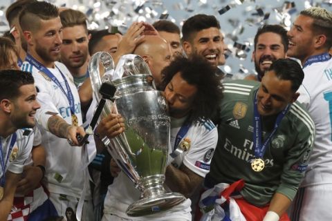 Real Madrid's Marcelo kisses the trophy after winning the Champions League Final soccer match between Real Madrid and Liverpool at the Olimpiyskiy Stadium in Kiev, Ukraine, Saturday, May 26, 2018. (AP Photo/Efrem Lukatsky)