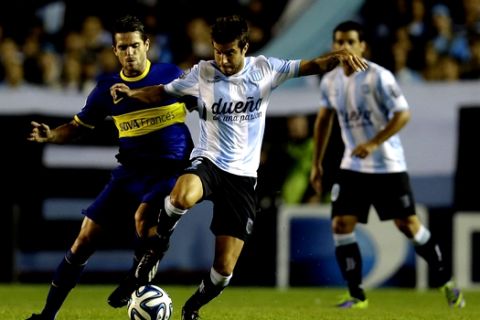 Boca Juniors' Fernando Gago, left, fights for the ball with Racing Club's Francisco Cerro during an Argentine league soccer match in Buenos Aires, Argentina, Sunday, March 9, 2014. (AP Photo/Natacha Pisarenko)