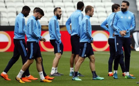 The Olympique Marseille (OM) soccer team with Konstantínos Mítroglou, right, walk, during a training session, at the Groupama stadium in Decines, outside Lyon, central France, Tuesday, May 15, 2018. Marseille will play Atletico Madrid in the Europa League final on Wednesday. (AP Photo/Laurent Cipriani)
