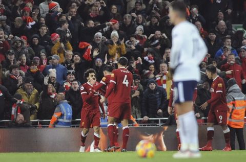 Liverpool's Mohamed Salah, left, celebrates after scoring his side's second goal during the English Premier League soccer match between Liverpool and Tottenham Hotspur at Anfield, Liverpool, England, Sunday, Feb. 4, 2018. (AP Photo/Rui Vieira)