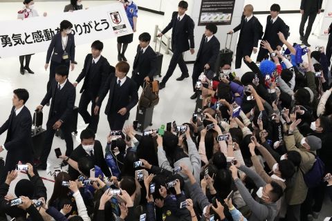 Supporters use smartphones to record the Japanese national soccer team returning home from the World Cup in Qatar at the Narita International Airport in Narita, east of Tokyo, Wednesday, Dec. 7, 2022. (AP Photo/Shuji Kajiyama)