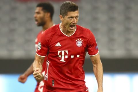Bayern's Robert Lewandowski celebrates after scoring his team's first goal from the penalty spot during the Champions League round of 16 second leg soccer match between Bayern Munich and Chelsea at Allianz Arena in Munich, Germany, Saturday, Aug. 8, 2020. (AP Photo/Matthias Schrader)