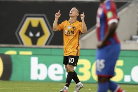 Wolverhampton Wanderers' Daniel Podence reacts after scoring his team's first goal during the English Premier League soccer match between Wolverhampton Wanderers and Crystal Palace at Molineux Stadium in Wolverhampton, England, Monday, July 20, 2020. (AP Photo/Martin Rickett,Pool)