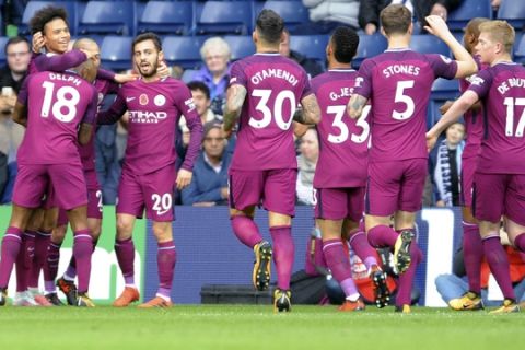 Manchester City's Leroy Sane, left, celebrates with teammates after scoring his side's first goal, during the English Premier League soccer match between West Bromwich Albion and Manchester City, at the Hawthorns in West Bromwich, England, Saturday, Oct. 28, 2017. (AP Photo/Rui Vieira)