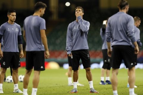 Real Madrid's Cristiano Ronaldo, center, looks up during a training session at the Millennium Stadium in Cardiff, Wales Friday June 2, 2017. Real Madrid will play Juventus in the final of the Champions League soccer match in Cardiff on Saturday. (AP Photo/Kirsty Wigglesworth)
