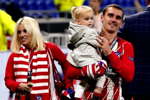 Atletico's Antoine Griezmann celebrates with his wife Erika Choperana, left, and his daughter Mia Griezmann, his team's victory during the Europa League Final soccer match between Marseille and Atletico Madrid at the Stade de Lyon in Decines, outside Lyon, France, Wednesday, May 16, 2018. (AP Photo/Thibault Camus)