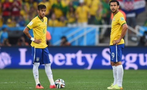 SAO PAULO, BRAZIL - JUNE 12:  Neymar (L) and Fred of Brazil wait to kick off in the first half during the 2014 FIFA World Cup Brazil Group A match between Brazil and Croatia at Arena de Sao Paulo on June 12, 2014 in Sao Paulo, Brazil.  (Photo by Christopher Lee/Getty Images)