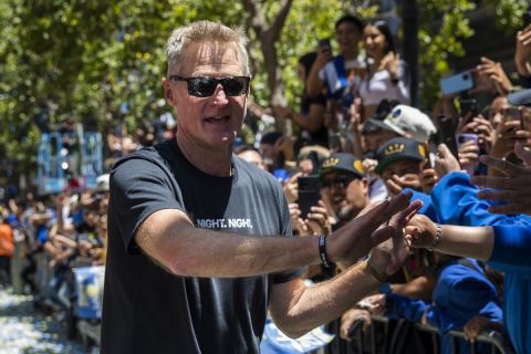 Golden State Warriors head coach Steve Kerr high-fives the crowd during the NBA Championship parade in San Francisco, Monday, June 20, 2022, in San Francisco. (AP Photo/John Hefti)
