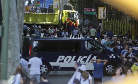 A truck and a police van block one of the roads leading to Cibeles square for security reasons, where Real Madrid players will celebrate after winning the Champions League final, Madrid, Spain, Sunday, June 4, 2017. Real Madrid became the first team in the Champions League era to win back-to-back titles with their 4-1 victory over Juventus in Cardiff Saturday. (AP Photo/Paul White)