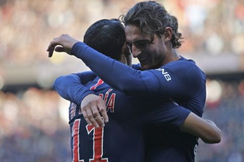PSG's Adrien Rabiot, right, celebrates with his teammate PSG's Angel Di Maria after scoring his side's second goal during the French League One soccer match between Paris-Saint-Germain and Amiens at the Parc des Princes stadium in Paris, France, Saturday, Oct. 20, 2018. (AP Photo/Francois Mori)