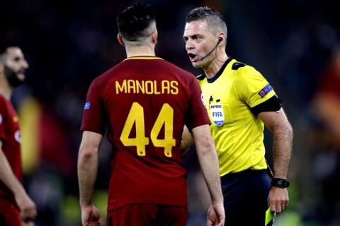 Referee Damir Skomina shows a yellow card to Roma's Kostas Manolas during the Champions League semifinal second leg soccer match between Roma and Liverpool at the Olympic Stadium in Rome, Wednesday, May 2, 2018. (AP Photo/Alessandra Tarantino)