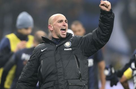 Inter Milan Argentine midfielder Esteban Cambiasso celebrates after winning the Serie A soccer match between Inter Milan and AC Milan at the San Siro stadium in Milan, Italy, Sunday, Dec. 22, 2013. A late goal from Rodrigo Palacio gave Inter Milan a 1-0 win over city rival AC Milan in an entertaining derby match in Serie A on Sunday. Palacio struck four minutes from time to send three quarters of San Siro into a frenzy. (AP Photo/Antonio Calanni)