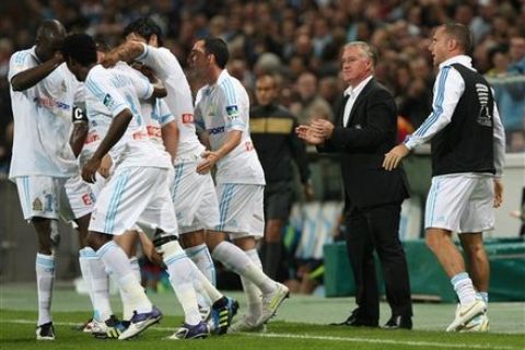 Marseille's French coach Didier Deschamps, second right,  reacts  after Marseille's French forward Andre-Pierre Gignac, scored against Lens , during the League Cup soccer match, at the Velodrome Stadium, in Marseille, southern France, Tuesday, Oct. 25, 2011. (AP Photo/Claude Paris)