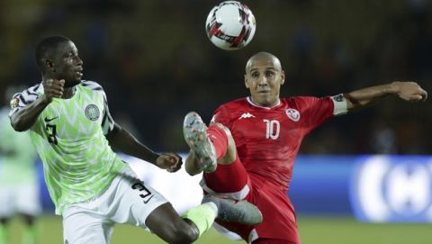 Tunisia's Wahbi Khazri and Nigeria's Jamilu Collins fight for the ball during the African Cup of Nations third place soccer match between Nigeria and Tunisia in Al Salam stadium in Cairo, Egypt, Wednesday, July 17, 2019. (AP Photo/Hassan Ammar)
