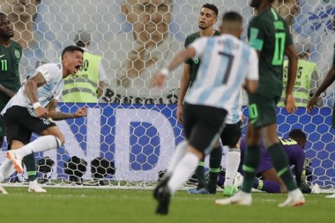 Argentina's Marcos Rojo, left, scores his side second goal during the group D match between Argentina and Nigeria, at the 2018 soccer World Cup in the St. Petersburg Stadium in St. Petersburg, Russia, Tuesday, June 26, 2018. (AP Photo/Ricardo Mazalan)