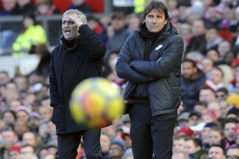 Manchester United coach Jose Mourinho, left, and Chelsea's team manager Antonio Conte react during the English Premier League soccer match between Manchester United and Chelsea at the Old Trafford stadium in Manchester, England, Sunday, Feb. 25, 2018. (AP Photo/Rui Vieira)