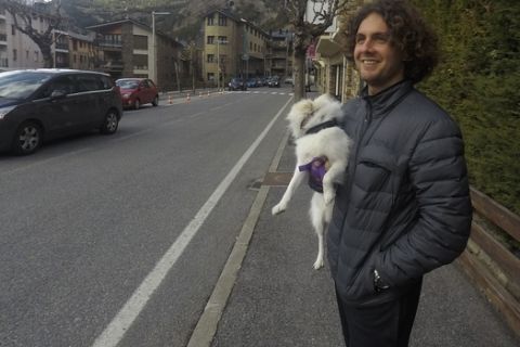 Argentina's Marco Trungelliti holds his dog in the principality of Andorra Monday, April 8, 2019. Blowing the whistle on betting-related corruption that is eating at tennis' credibility has come at a cost for the Argentine whose mad-dash road trip to Roland Garros last year caused a sensation. (AP Photo/John Leicester)