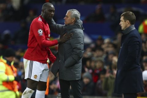 CSKA's head coach Viktor Goncharenko, right, watches as Manchester United's head coach Jose Mourinho hugs with Romelu Lukaku as he scored his team first goal during the Champions League group A soccer match between Manchester United and CSKA Moscow in Manchester, England, Tuesday, Dec. 5, 2017. (AP Photo/Dave Thompson)