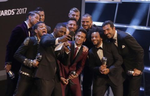 The FIFA FIFPro World 11 award winner and soccer players pose for a selfi with English actor Idris Elba after receiving their awards during The Best FIFA 2017 Awards at the Palladium Theatre in London, Monday, Oct. 23, 2017. (AP Photo/Alastair Grant)