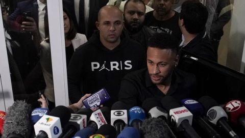 Brazilian soccer player Neymar speaks to journalists as he leaves a police station in Rio de Janeiro, Brazil, Thursday, June 6, 2019. Neymar went to the Rio de Janeiro police headquarters Thursday evening in an investigation linked to a womans rape allegation against him. (AP Photo/Leo Correa)