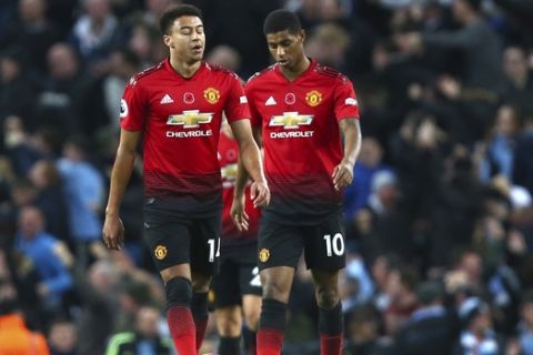 Manchester United's Jesse Lingard, left, and Manchester United's Marcus Rashford react during the English Premier League soccer match between Manchester City and Manchester United at the Etihad stadium in Manchester, England, Sunday, Nov. 11, 2018. (AP Photo/Dave Thompson)