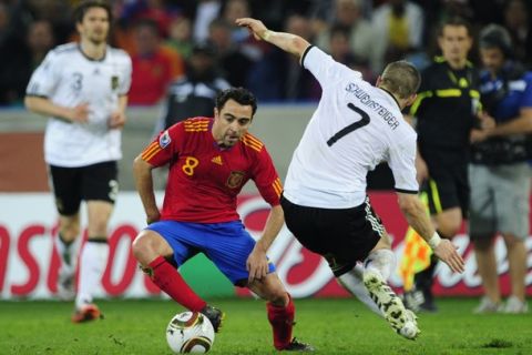 Spain's midfielder Xavi (L) and Germany's midfielder Bastian Schweinsteiger fight for the ball during the 2010 World Cup semi-final football match between Germany and Spain on July 7, 2010 at Moses Mabhida Stadium in Durban. NO PUSH TO MOBILE / MOBILE USE SOLELY WITHIN EDITORIAL ARTICLE -      AFP PHOTO / JOHN MACDOUGALL (Photo credit should read JOHN MACDOUGALL/AFP/Getty Images)