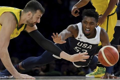 Australia's Andrew Bogut, left and United States Donovan Mitchell, right compete for the ball during their exhibition basketball game in Melbourne, Saturday, Aug. 24, 2019. (AP Photo/Andy Brownbill)