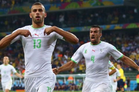 CURITIBA, BRAZIL - JUNE 26:  Islam Slimani of Algeria (L) celebrates scoring his team's first goal with Essaid Belkalem during the 2014 FIFA World Cup Brazil Group H match between Algeria and Russia at Arena da Baixada on June 26, 2014 in Curitiba, Brazil.  (Photo by Julian Finney/Getty Images)