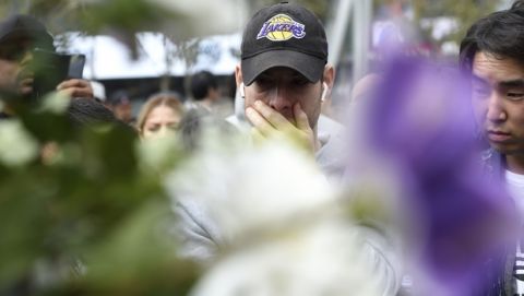 Lenard Gorokhov, of Calabasas, Calif., reacts at a makeshift memorial for former NBA player Kobe Bryant outside of the Staples Center on Sunday, Jan. 26, 2020, in Los Angeles. Bryant died Sunday in a helicopter crash near Calabasas, Calif. He was 41. (AP Photo/Chris Pizzello)