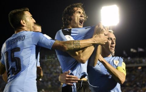 Uruguay's Edinson Cavani, center, celebrates after scoring against Bolivia during a 2018 World Cup qualifying soccer match in Montevideo, Uruguay, Tuesday, Oct. 10, 2017. (AP Photo/Matilde Campodonico)
