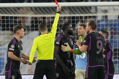 Bayern's Dayot Upamecano receives a red card by referee Francois Letexier during a Champions League round of 16 first leg soccer match between Lazio and Bayern Munich, at Rome's Olympic Stadium, Wednesday, Feb. 14, 2024. (AP Photo/Andrew Medichini)