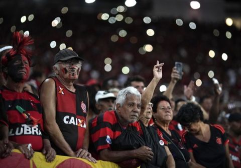 Fans take part in an homage for the 10 teenage players killed by a fire at the Flamengo training center last Friday, ahead of a soccer match between Flamengo and Fluminense at the Maracana Stadium, in Rio de Janeiro, Brazil, Thursday, Feb. 14, 2019. (AP Photo/Leo Correa)