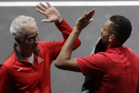 World's Nick Kyrgios clap hands with his team's captain John McEnroe during the Laver Cup tennis match against Europe's Tomas Berdych in Prague, Czech Republic, Saturday, Sept. 23, 2017. (AP Photo/Petr David Josek)