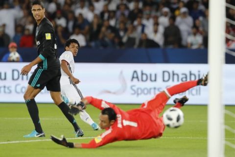 Al Jazira's Romarinho, left, scores the opening goal during the Club World Cup semifinal soccer match between Real Madrid and Al Jazira Club at Zayed sport city in Abu Dhabi, United Arab Emirates, Wednesday, Dec. 13, 2017. (AP Photo/Hassan Ammar)