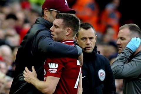 Liverpool manager Juergen Klopp hugs Liverpool's James Milner who was substituted after sustaining an injury during the English Premier League soccer match between Liverpool and Manchester City at Anfield stadium in Liverpool, England, Sunday, Oct. 7, 2018. (AP Photo/Rui Vieira)