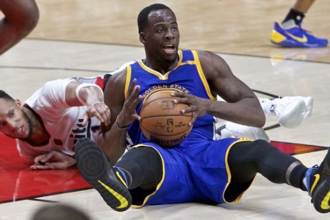 Golden State Warriors forward Draymond Green, right, and Portland Trail Blazers guard Evan Turner dive for a loose ball during the second half of Game 3 of an NBA basketball first-round playoff series Saturday, April 22, 2017, in Portland, Ore. The Warriors won 119-113. (AP Photo/Craig Mitchelldyer)
