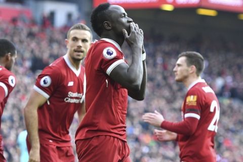 Liverpool's Sadio Mane celebrates scoring his side's first goal of the game during the English Premier League soccer match between Liverpool and Bournemouth at Anfield, Liverpool, England. Saturday April 14, 2018. (Anthony Devlin/PA via AP)
