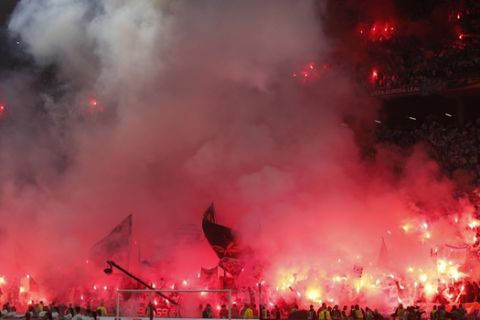 Soccer fans burn flares before the Europa League Final soccer match between Marseille and Atletico Madrid at the Stade de Lyon outside Lyon, France, Wednesday, May 16, 2018. (AP Photo/Thibault Camus)