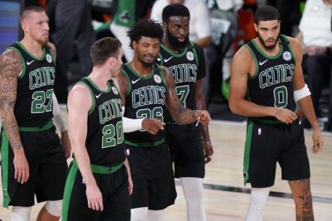 Boston Celtics players talk during a timeout in the first half of an NBA conference final playoff basketball game against the Miami HeatFriday, Sept. 25, 2020, in Lake Buena Vista, Fla. (AP Photo/Mark J. Terrill)