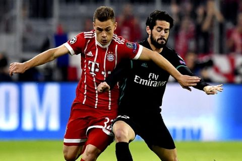 Bayern's Joshua Kimmich, left, and Real Madrid's Isco challenge for the ball during the semifinal first leg soccer match between FC Bayern Munich and Real Madrid at the Allianz Arena stadium in Munich, Germany, Wednesday, April 25, 2018. (AP Photo/Kerstin Joensson)
