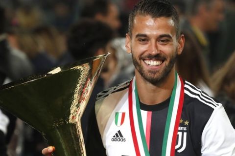 Juventus' Leonardo Spinazzola holds the Serie A soccer title trophy, at the Allianz Stadium in Turin, Italy, Sunday, May 19, 2019. (AP Photo/Antonio Calanni)
