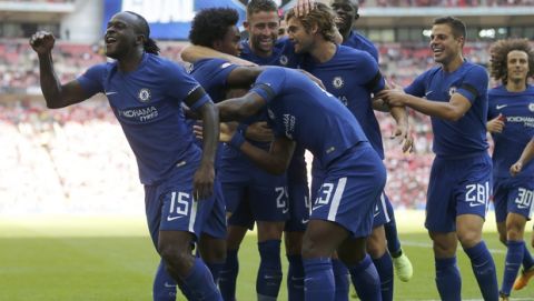 Chelsea's Victor Moses, left, celebrates with teammates after scoring his side's first goal during the English Community Shield soccer match between Arsenal and Chelsea at Wembley Stadium in London, Sunday, Aug. 6, 2017. (AP Photo/Frank Augstein)