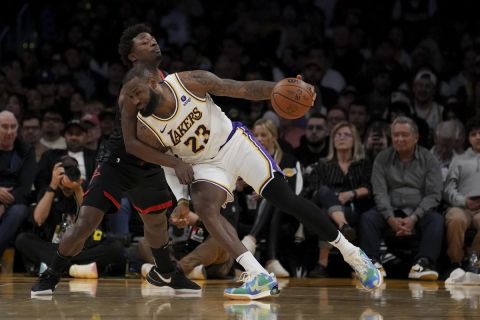 Los Angeles Lakers forward LeBron James (23) drives against Houston Rockets forward Jae'Sean Tate during the first half of an NBA basketball game in Los Angeles, Sunday, Nov. 19, 2023. (AP Photo/Eric Thayer)