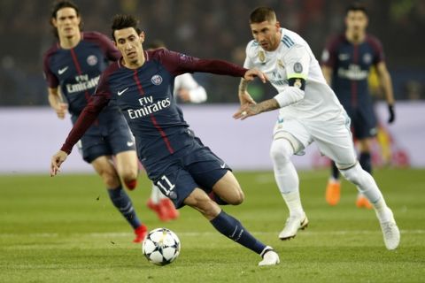 PSG's Angel Di Maria, left, and Real Madrid's Sergio Ramos, right, vie for the ball during the Champions League round of sixteen second leg soccer match between Paris St. Germain and Real Madrid at the Parc des Princes stadium in Paris, France, Tuesday, March 6, 2018. (AP Photo/Christophe Ena)