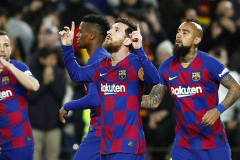 Barcelona's Lionel Messi, second right, celebrates after scoring his side's opening goal from the penalty spot during a Spanish La Liga soccer match between Barcelona and Real Sociedad at the Camp Nou stadium in Barcelona, Spain, Saturday, March 7, 2020. (AP Photo/Joan Monfort)