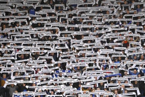 Fans hold scarves for Leicester City Chairman Vichai Srivaddhanaprabha during the Premier League match at the King Power Stadium, Leicester. Saturday Nov 10, 2018. (Joe Giddens/PA via AP)