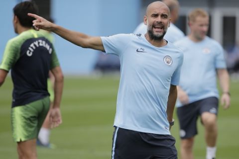 Manchester City Football Club's manager Pep Guardiola looks over the field during a practice in Orangeburg, N.Y., Monday, July 23, 2018. Manchester City is scheduled to play Liverpool in New Jersey on Wednesday, July 25, 2018. (AP Photo/Seth Wenig)