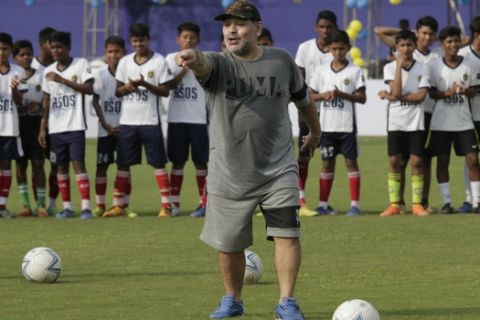 Diego Maradona, gestures as he attends a football clinic and workshop for young aspiring soccer players in Kadambagachhi, about 45 kilometers (28 miles) north of Kolkata, India, Tuesday, Dec. 12, 2017. The 1986 World Cup-winning captain for Argentina is on a three day visit to Kolkata. (AP Photo/Bikas Das)