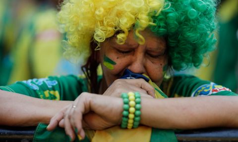 A Brazil soccer fan reacts at the end of a live broadcast of the Russia World Cup quarterfinal match between Brazil and Belgium in Rio de Janeiro, Brazil, Friday, July 6, 2018. Belgium knocked Brazil out of the World Cup and advanced to the semi-finals.  (AP Photo/Leo Correa)