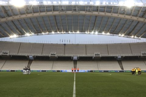 Players of PAOK, left, and AEK Athens, prepare to compete in the Greek Cup final at the empty of fans Olympic stadium in Athens, Saturday, May 11, 2019. (AP Photo/Yorgos Karahalis)